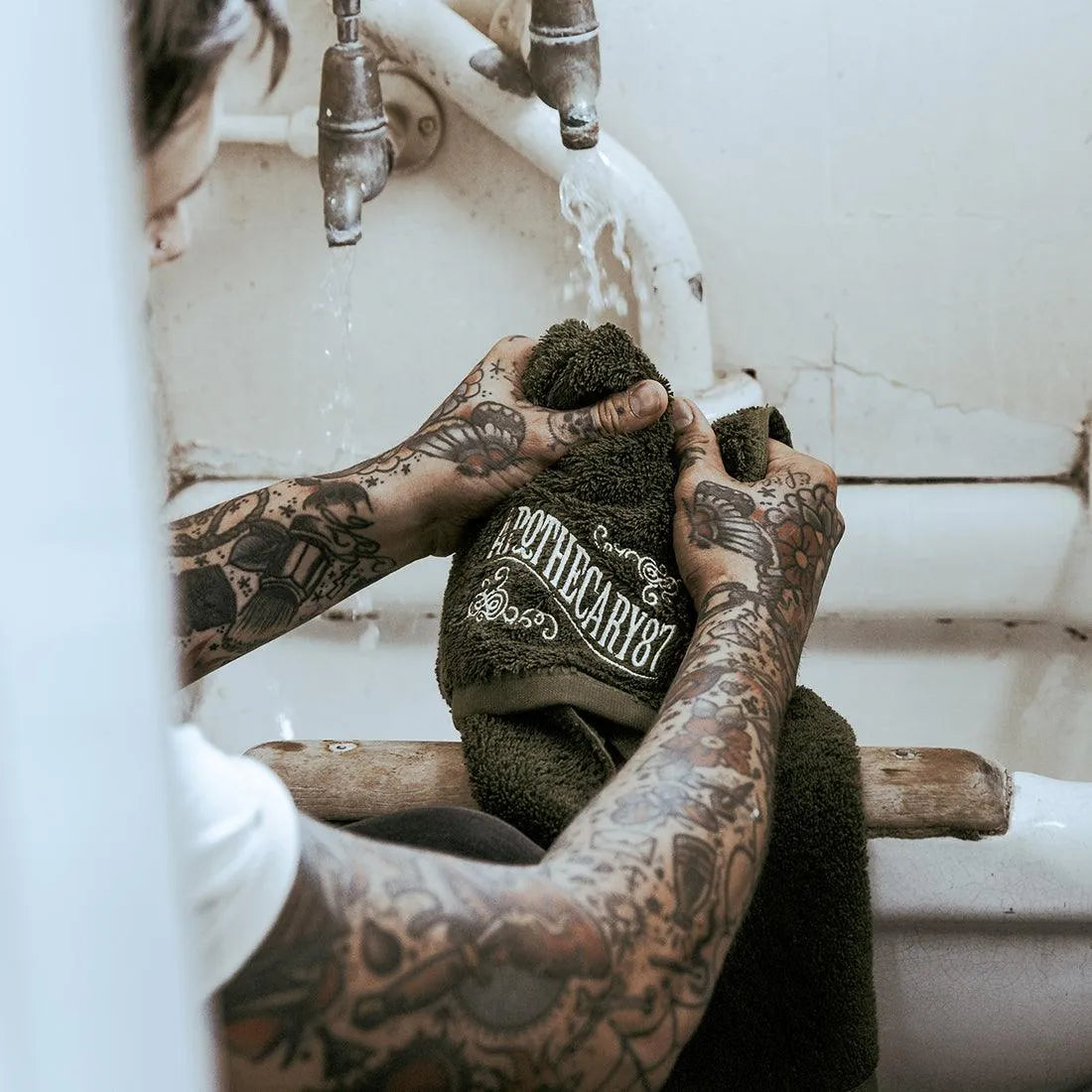 Apothecary 87 soft Shave Towel held by tattoo man shaving