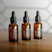 Apothecary 87 conditioning Beard Oil bottles in line. Fresh vanilla and mango fragrance