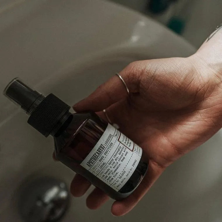 Apothecary 87 cleansing Hand Sanitiser bottle being held in hand