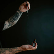 Apothecary 87 healthy Beard Oil dispensed from dropper into hands
