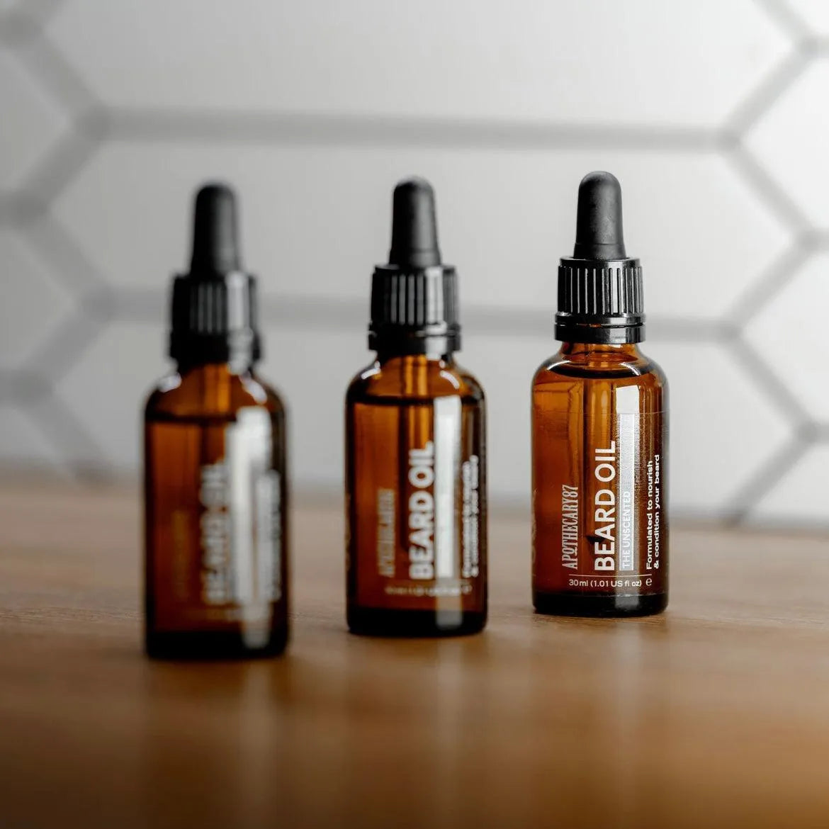 Apothecary 87 conditioning Beard Oil bottles in line. No fragrance for sensitive skin