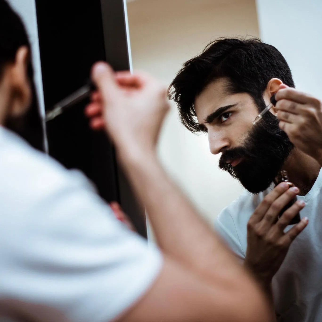 Apothecary 87 Beard Set bundle including everything for healthy beard care. Gift set showcasing man applying beard oil