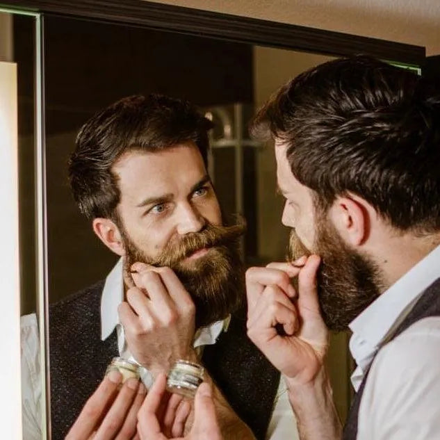 Apothecary 87 styling moustache wax being applied by man with beard and moustache